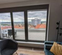 Living Room with first balcony overlooking the city.  Amazing views during the day and at night!