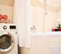 Bathroom with washing machine and dryer.