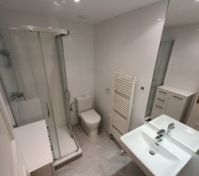 The bathroom with shower and toilet