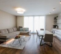 Kitchen & Living room with direct access to the terrace oriented to the South. All windows within the apartment have installed electric blinds.