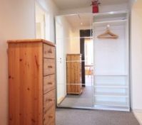 There is a large wardrobe with sliding mirror door in the entry hall