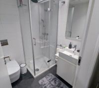 Bathroom, with standing shower, sink, toilet, towel rack and heated floors